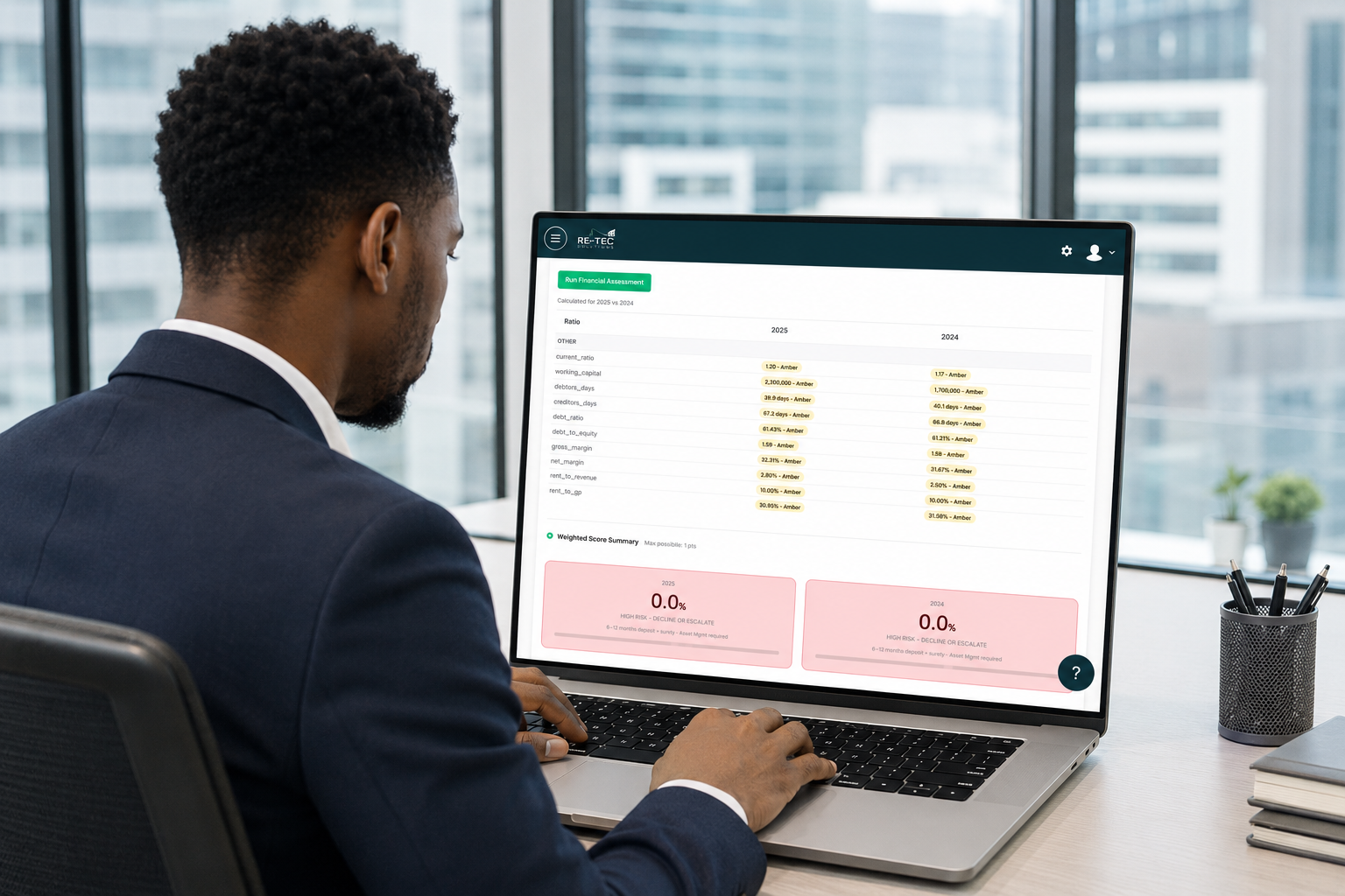 Professional reviewing RE-TEC's financial assessment dashboard on a laptop with a city skyline behind